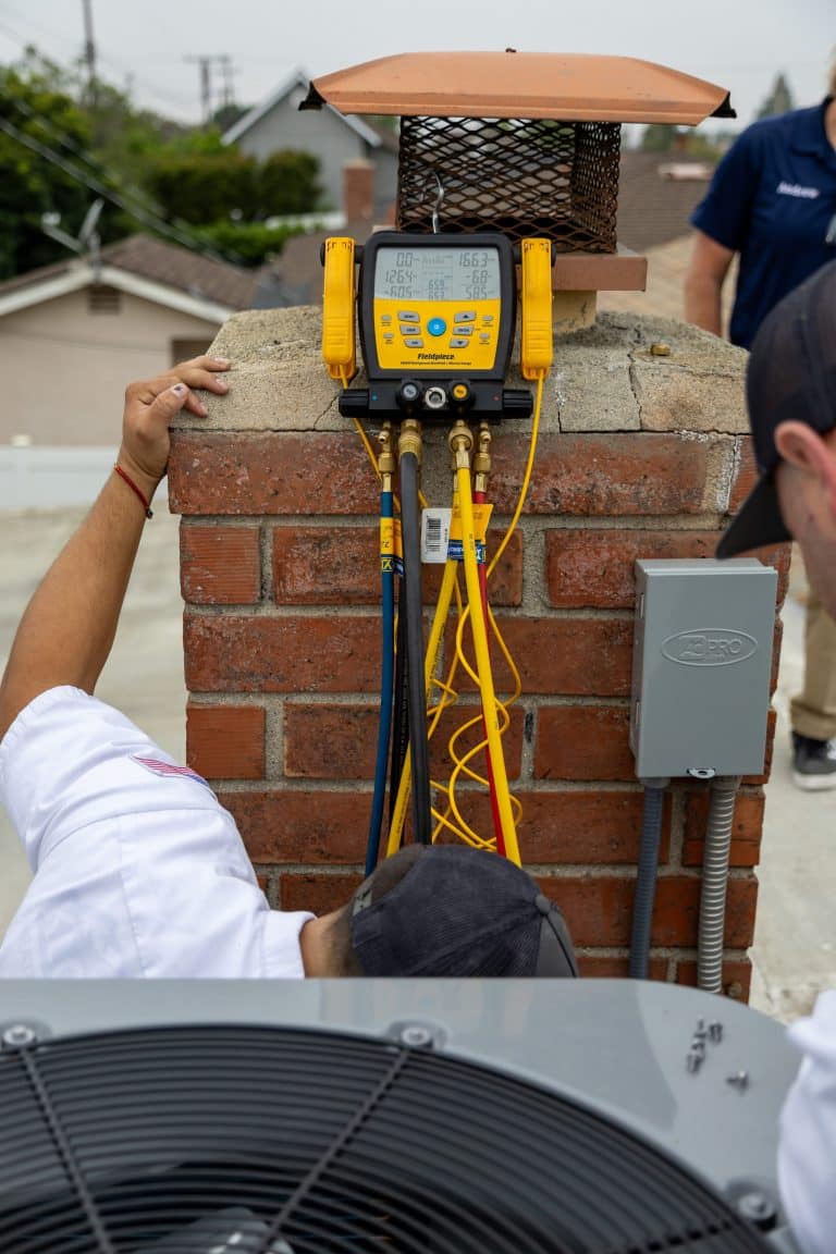 Professional technicians checking HVAC system