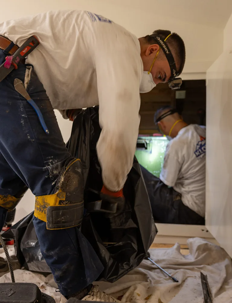 An HVAC Technician Cleaning the Heating System