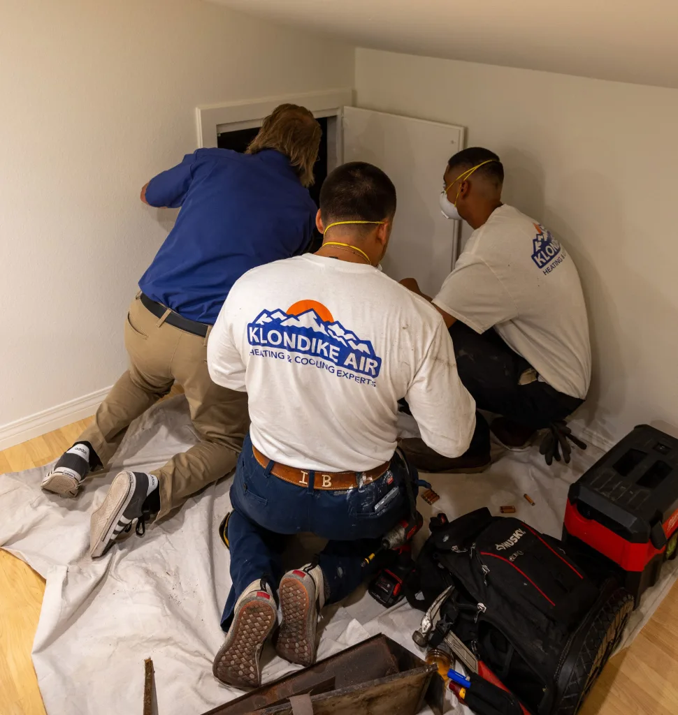 HVAC Technicians Inspecting Air Ducts for Cleaning